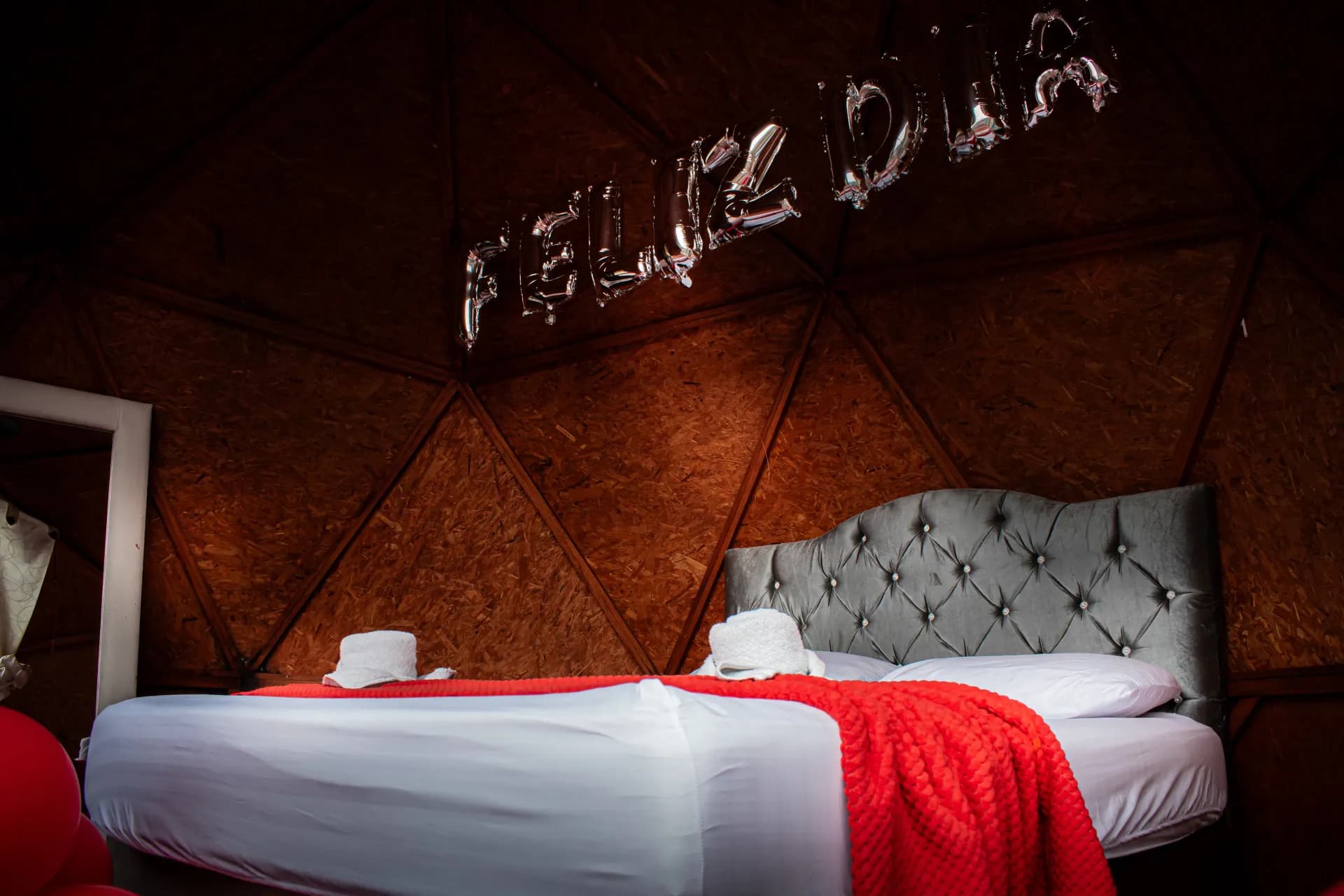 Interior de domo de glamping con cama y decoración romántica